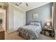 Comfortable bedroom features a ceiling fan, closet and serene blue accent wall for a peaceful retreat at 31840 Magna Gulf Loop, San Antonio, FL 33576