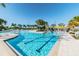 Community pool with beach-style entry, lap lanes, plenty of seating, umbrellas and palm trees at 31840 Magna Gulf Loop, San Antonio, FL 33576