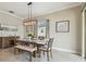 Comfortable dining room with a modern light fixture, neutral colors, and seating for six at 31840 Magna Gulf Loop, San Antonio, FL 33576