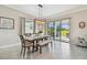Bright dining room with a modern light fixture and views of the outdoor patio at 31840 Magna Gulf Loop, San Antonio, FL 33576