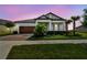 Beautiful single-Gathering home featuring a brick driveway, attached garage, and manicured landscaping at 31840 Magna Gulf Loop, San Antonio, FL 33576