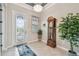 Welcoming foyer with a decorative glass door, tiled floor, and an antique grandfather clock at 31840 Magna Gulf Loop, San Antonio, FL 33576