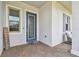Charming front entrance with a decorative glass door, a welcoming sign, and stylish brick pavers leading up to the entrance at 31840 Magna Gulf Loop, San Antonio, FL 33576