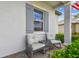 Cozy front porch featuring rocking chairs and a small table, perfect for relaxing and enjoying the outdoors at 31840 Magna Gulf Loop, San Antonio, FL 33576