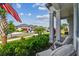 Inviting front porch with comfortable seating and charming landscaping overlooking a manicured lawn and lovely neighborhood street at 31840 Magna Gulf Loop, San Antonio, FL 33576