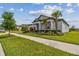 Attractive home with lush green lawn, palm trees, and neatly trimmed hedges defining the property's border at 31840 Magna Gulf Loop, San Antonio, FL 33576
