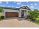 Well-maintained home featuring a spacious driveway, landscaped garden beds, and a two-car garage at 31840 Magna Gulf Loop, San Antonio, FL 33576