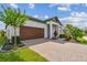 Inviting home with a brick-paved driveway, neatly trimmed lawn, and a picturesque front garden at 31840 Magna Gulf Loop, San Antonio, FL 33576