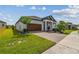 Attractive home with a large driveway, manicured lawn, and a landscaped garden adding to its charm at 31840 Magna Gulf Loop, San Antonio, FL 33576