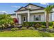 Eye-catching home with vibrant landscaping, featuring colorful plants and a welcoming front entrance at 31840 Magna Gulf Loop, San Antonio, FL 33576