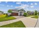 Inviting home with a spacious driveway, well-kept lawn, and meticulously landscaped front yard at 31840 Magna Gulf Loop, San Antonio, FL 33576