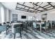 A community game room featuring tables, chairs, elegant chandeliers, and contemporary wall art at 31840 Magna Gulf Loop, San Antonio, FL 33576
