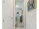 Hallway featuring carpet and a doorway leading into a bedroom with a ceiling fan and natural light at 31840 Magna Gulf Loop, San Antonio, FL 33576