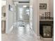 Elegant hallway featuring tiled floors, a decorative front door, and a mini-bar area at 31840 Magna Gulf Loop, San Antonio, FL 33576