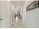 Spacious hallway with neutral tones, tiled floors, and recessed lighting leads to the living areas at 31840 Magna Gulf Loop, San Antonio, FL 33576