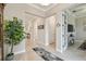 Bright hallway with tile flooring featuring doorways leading to various rooms in the home at 31840 Magna Gulf Loop, San Antonio, FL 33576