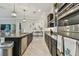 Modern kitchen features granite countertops, stainless steel appliances, and dark wood cabinetry in an open layout at 31840 Magna Gulf Loop, San Antonio, FL 33576