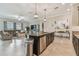 Kitchen island with sink overlooks the living room in an open floor plan, with stainless steel appliances at 31840 Magna Gulf Loop, San Antonio, FL 33576