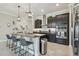 Bright open kitchen featuring a large island with bar seating, pendant lighting, and stainless steel appliances at 31840 Magna Gulf Loop, San Antonio, FL 33576
