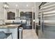 Modern kitchen with stainless steel appliances, granite countertops, dark cabinetry, and tiled floors at 31840 Magna Gulf Loop, San Antonio, FL 33576