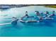 Aerial view of a community's resort style lagoon with inflatable water park at 31840 Magna Gulf Loop, San Antonio, FL 33576