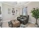 Cozy living room with leather recliners, a wooden coffee table, and neutral walls creates a relaxing atmosphere at 31840 Magna Gulf Loop, San Antonio, FL 33576