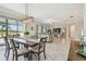 Bright open-plan living and dining area with water views, tile flooring, and modern lighting at 31840 Magna Gulf Loop, San Antonio, FL 33576