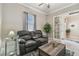 Cozy living room with leather recliners, a wooden coffee table, and neutral walls creates a relaxing atmosphere at 31840 Magna Gulf Loop, San Antonio, FL 33576