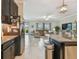 Open floor plan featuring the kitchen and living room, complete with stainless steel appliances and backyard access at 31840 Magna Gulf Loop, San Antonio, FL 33576