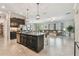 Open concept living room, kitchen, and dining area with tile floors and neutral paint colors at 31840 Magna Gulf Loop, San Antonio, FL 33576