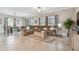 Inviting living room with a large sectional sofa, neutral decor, and sliding doors to the outdoor space at 31840 Magna Gulf Loop, San Antonio, FL 33576