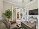 Living room with recliners, a wooden coffee table, and doorway, creating a welcoming and functional space at 31840 Magna Gulf Loop, San Antonio, FL 33576