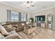 Cozy living room showcasing a comfortable sectional sofa, large windows, and stylish furniture arrangement at 31840 Magna Gulf Loop, San Antonio, FL 33576