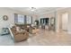 Spacious living room with a plush sectional sofa, large windows, and elegant decor at 31840 Magna Gulf Loop, San Antonio, FL 33576