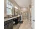 Elegant main bathroom with granite countertops, double sinks, and a large glass-enclosed shower at 31840 Magna Gulf Loop, San Antonio, FL 33576