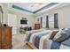 Elegant main bedroom with a comfortable bed, a flat-screen TV, and ample natural light streaming through the windows at 31840 Magna Gulf Loop, San Antonio, FL 33576