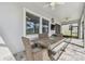 Covered outdoor dining area with ceiling fan, woven chairs, and planked table with bench seating at 31840 Magna Gulf Loop, San Antonio, FL 33576