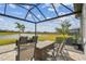 Screened patio with outdoor lounge seating and an open view of the lawn and lake at 31840 Magna Gulf Loop, San Antonio, FL 33576