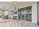 Covered patio with ceiling fan, tiled floor, outdoor television, grill cart, and sliding doors to the interior at 31840 Magna Gulf Loop, San Antonio, FL 33576