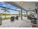 Spacious screened patio overlooking a serene pond offers outdoor living and dining options with scenic views at 31840 Magna Gulf Loop, San Antonio, FL 33576