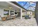 Spacious screened patio with dining and seating areas and an outdoor kitchen and grill at 31840 Magna Gulf Loop, San Antonio, FL 33576
