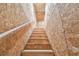 Stairway leading to an upper storage area featuring unfinished walls and wood steps at 31840 Magna Gulf Loop, San Antonio, FL 33576
