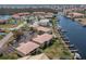 Aerial view of waterfront condos, boat docks, and lush landscaping at 3221 White Ibis Ct # C1, Punta Gorda, FL 33950