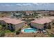 Aerial view of a beautiful community with a pool, lush landscaping, and ample parking at 3221 White Ibis Ct # C1, Punta Gorda, FL 33950