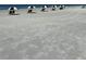Sandy beach view featuring umbrellas and chairs along the shoreline at 3221 White Ibis Ct # C1, Punta Gorda, FL 33950
