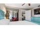 Bright bedroom with private balcony entrance, featuring a tranquil design and wood-look flooring at 3221 White Ibis Ct # C1, Punta Gorda, FL 33950