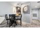 Cozy dining area with seating for four, complemented by stylish wood-look flooring and a decorative wall clock at 3221 White Ibis Ct # C1, Punta Gorda, FL 33950