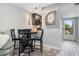 Bright dining area next to the entry door offers seating for four, and sleek, wood-look flooring at 3221 White Ibis Ct # C1, Punta Gorda, FL 33950