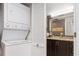 Convenient laundry area with a stackable washer and dryer next to bathroom at 3221 White Ibis Ct # C1, Punta Gorda, FL 33950