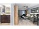 Living room view with wooden floors, bathroom, a leather sofa, and dining area at 3221 White Ibis Ct # C1, Punta Gorda, FL 33950